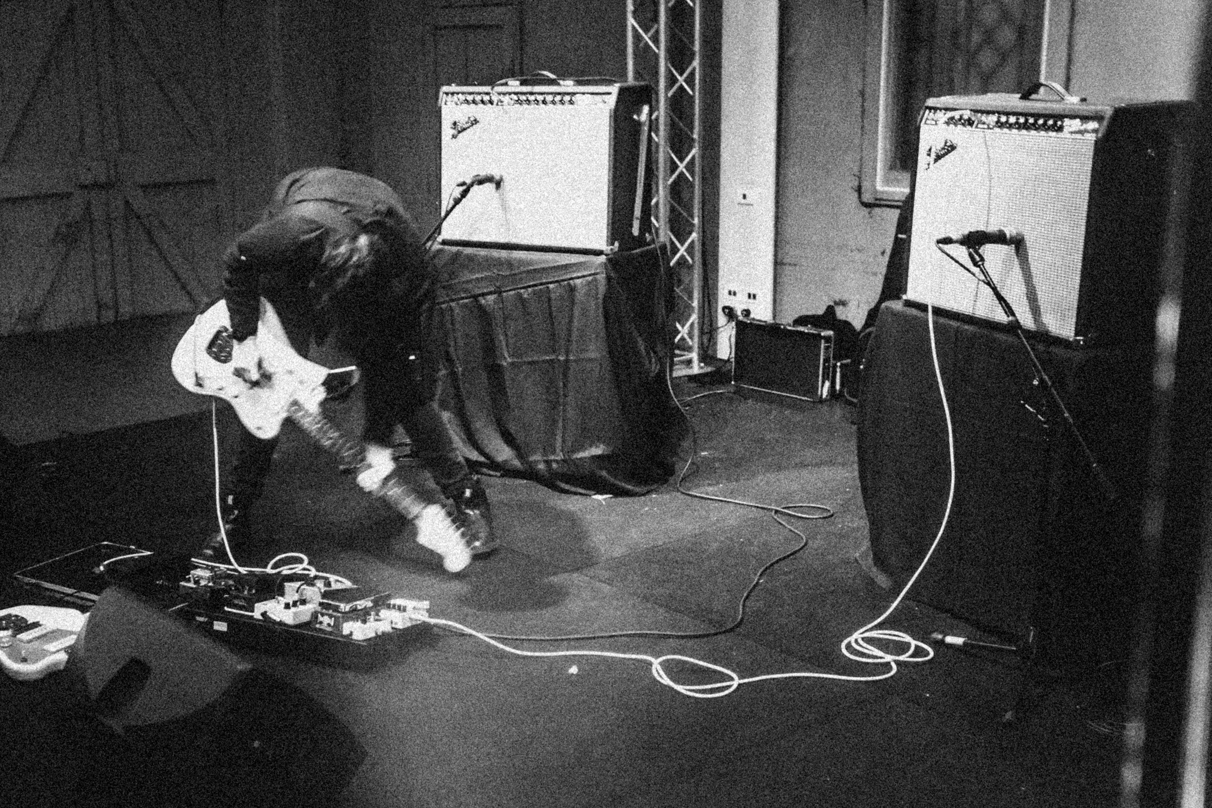 Hands and arms connected by strings, wires and bells